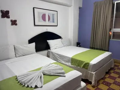 Cama o camas de una habitación en Hotel puerta de mar