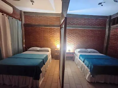 Cama o camas de una habitación en Casa Temazcal Madre Tierra