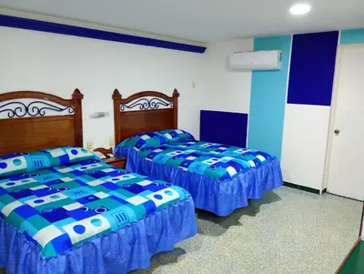 Cama o camas de una habitación en Hotel Los Cedros