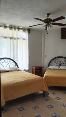 Cama o camas de una habitación en Quinta Corona Hospedaje Familiar