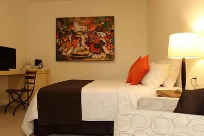 Cama o camas de una habitación en La Cochinilla Hotel Boutique