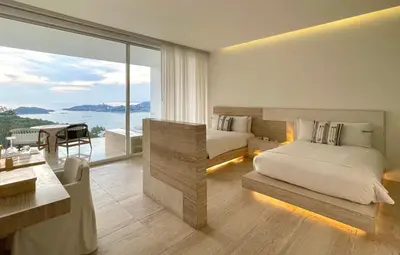 Cama o camas de una habitación en Encanto Acapulco