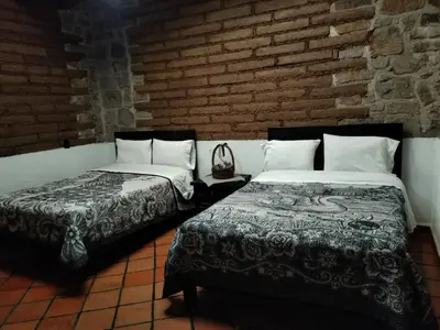 Cama o camas de una habitación en Cabañas y habitaciones Los Cedros