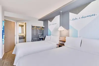 Cama o camas de una habitación en One Acapulco Costera
