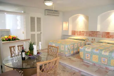 Cama o camas de una habitación en Hotel Suites Jazmín Acapulco