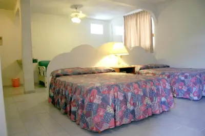 Cama o camas de una habitación en Hotel Suites Jazmín Acapulco