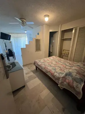 Cama o camas de una habitación en Hotel Suites Jazmín Acapulco