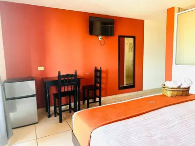 Cama o camas de una habitación en Hotel & Suites Cerro Roj0