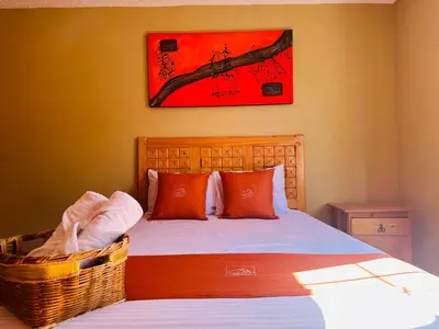 Cama o camas de una habitación en Hotel & Suites Cerro Roj0