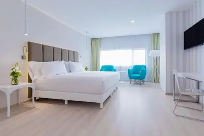 Cama o camas de una habitación en NH Puebla FINSA