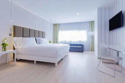 Cama o camas de una habitación en NH Puebla FINSA