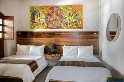 Cama o camas de una habitación en NaNa Vida Hotel Oaxaca