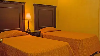Cama o camas de una habitación en Suites Bello Xochimilco