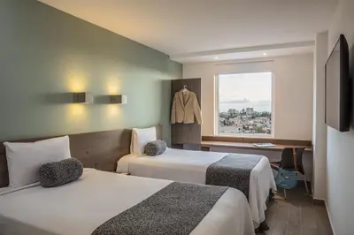 Cama o camas de una habitación en One Puebla Serdan