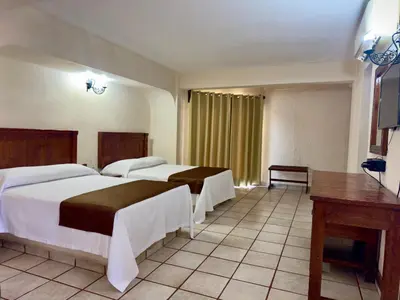 Cama o camas de una habitación en Hotel Hacienda María Eugenia Acapulco
