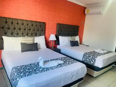 Cama o camas de una habitación en Hotel & Suites Bausan