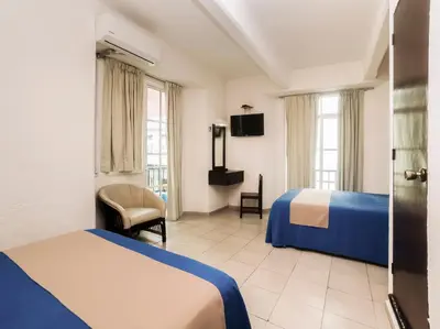 Cama o camas de una habitación en Hotel Trianon