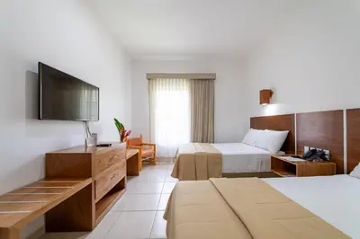 Cama o camas de una habitación en Hotel Castillo Huatulco & Beach Club
