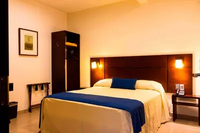 Cama o camas de una habitación en Hotel Real Alma