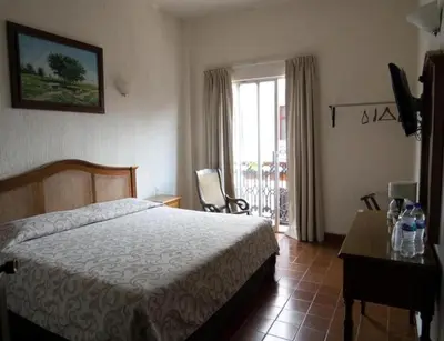Cama o camas de una habitación en Hotel Posada Doña Lala