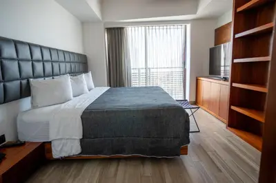 Cama o camas de una habitación en Sonata Hotel Puebla Angelópolis Distrito Sonata