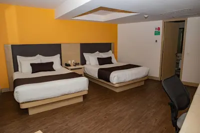 Cama o camas de una habitación en Plaza Poblana