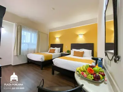Cama o camas de una habitación en Plaza Poblana