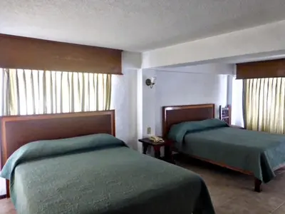 Cama o camas de una habitación en Hotel Bajo el Volcan