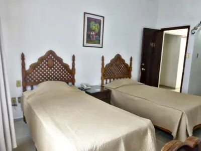 Cama o camas de una habitación en Hotel Bajo el Volcan