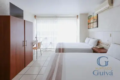 Cama o camas de una habitación en Hotel Guivá Huatulco