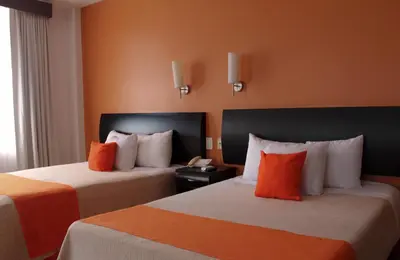 Cama o camas de una habitación en Hotel Baez Paraiso