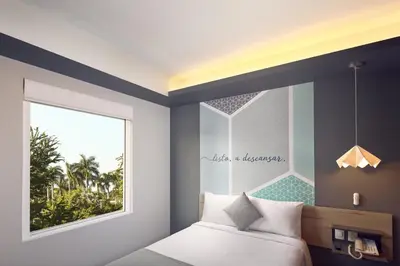 Cama o camas de una habitación en One Acapulco Diamante