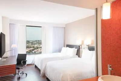 Cama o camas de una habitación en Fiesta Inn Express Puebla Explanada