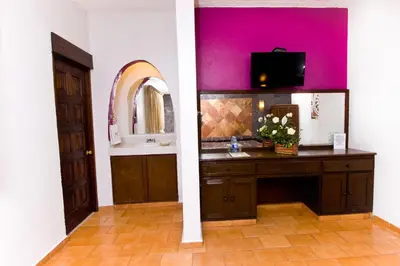 Una televisión o centro de entretenimiento en Hotel & Motel Hacienda Jiutepec