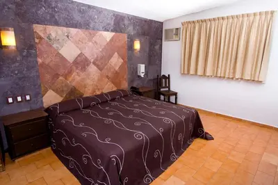 Cama o camas de una habitación en Hotel & Motel Hacienda Jiutepec