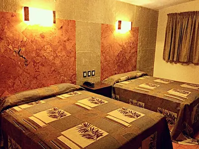 Cama o camas de una habitación en Hotel & Motel Hacienda Jiutepec