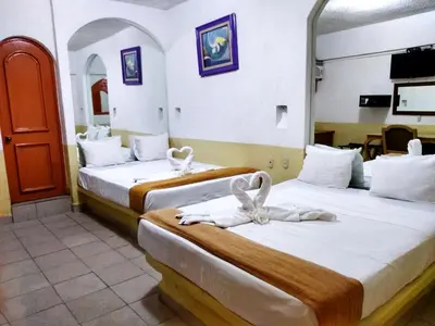 Cama o camas de una habitación en D'Cesar Hotel Acapulco