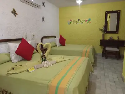 Cama o camas de una habitación en Hotel La Cabaña