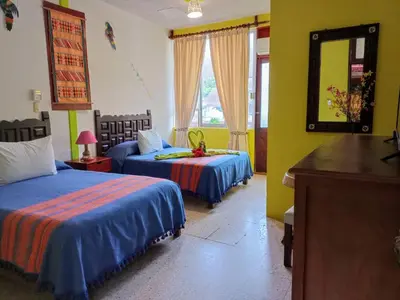 Cama o camas de una habitación en Hotel La Cabaña
