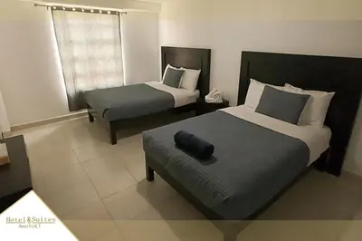 Cama o camas de una habitación en Hotel Y Suites Axolotl
