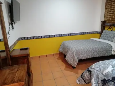 Cama o camas de una habitación en Hotel Y Suites Axolotl