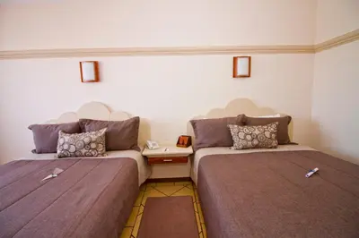 Cama o camas de una habitación en Hotel 9 Manantiales