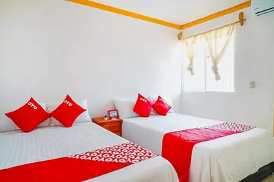 Cama o camas de una habitación en OYO Hospedaje Colibri