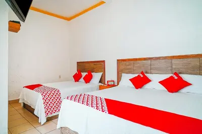Cama o camas de una habitación en OYO Hospedaje Colibri