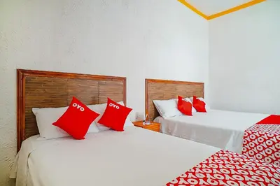 Cama o camas de una habitación en OYO Hospedaje Colibri