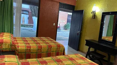 Cama o camas de una habitación en Hotel El Rancho