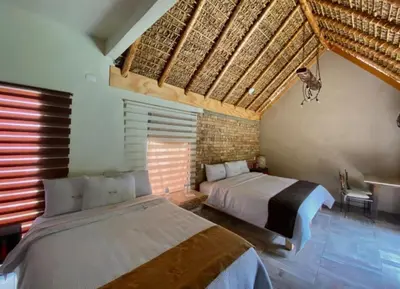 Cama o camas de una habitación en Hotel Villas Mariposas