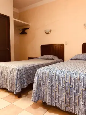 Cama o camas de una habitación en Hotel El Faro Malecon