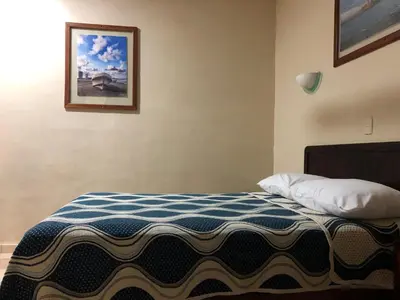 Cama o camas de una habitación en Hotel El Faro Malecon