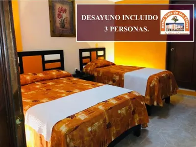 Cama o camas de una habitación en Hotel Villa De Las Flores